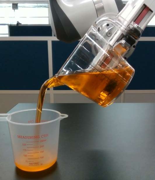 The robot pouring glycerol from a tilted cup